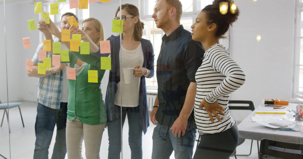 A group of diverse employees working together in a collaborative workspace